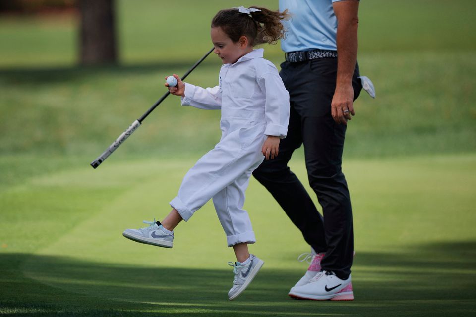 Rory McIlroy and his daughter Poppy during the par 3 contest. REUTERS/Mike Blake